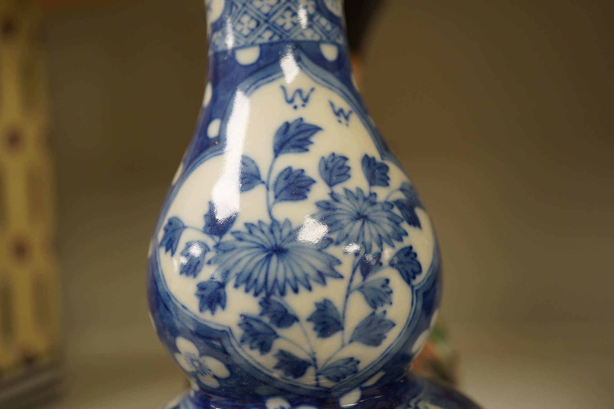 Two Chinese vases; a blue and white double gourd vase and famille noir vase, famille noir 19cm high. Condition - good